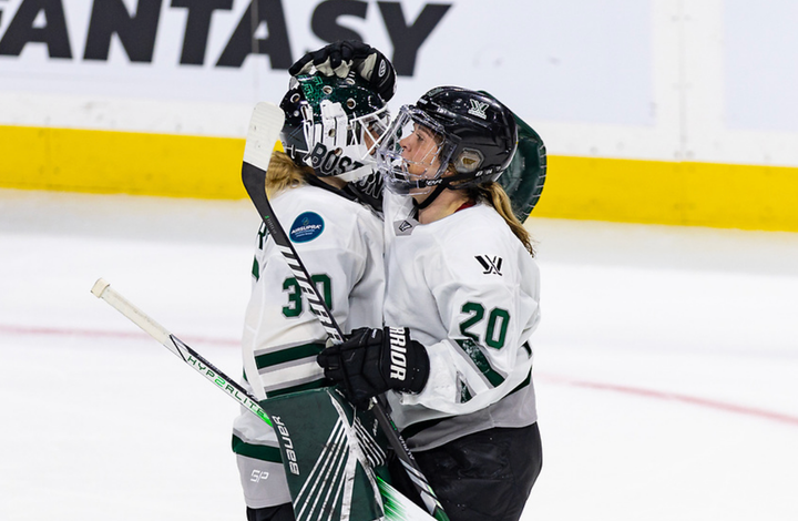 Brandt (right) hugs Söderberg (left) postgame and gives her a head tap. They are in white away uniforms.