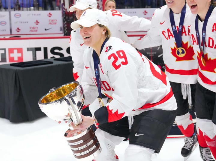 Marie-Philip Poulin holds Women's World Championship Trophy (Photo via: IIHF)