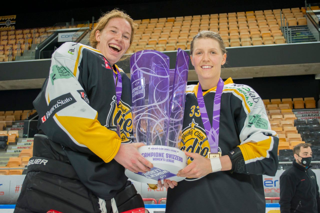 Allie Lehmann and Michelle Karvinen pose with the SWHL championship trophy.