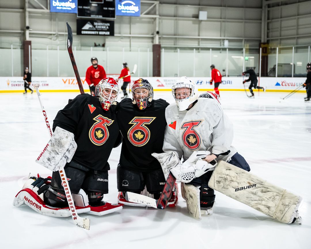 Elaine Chuli, Carly Jackson and Rachel Seeley pose for a photo at morning skate