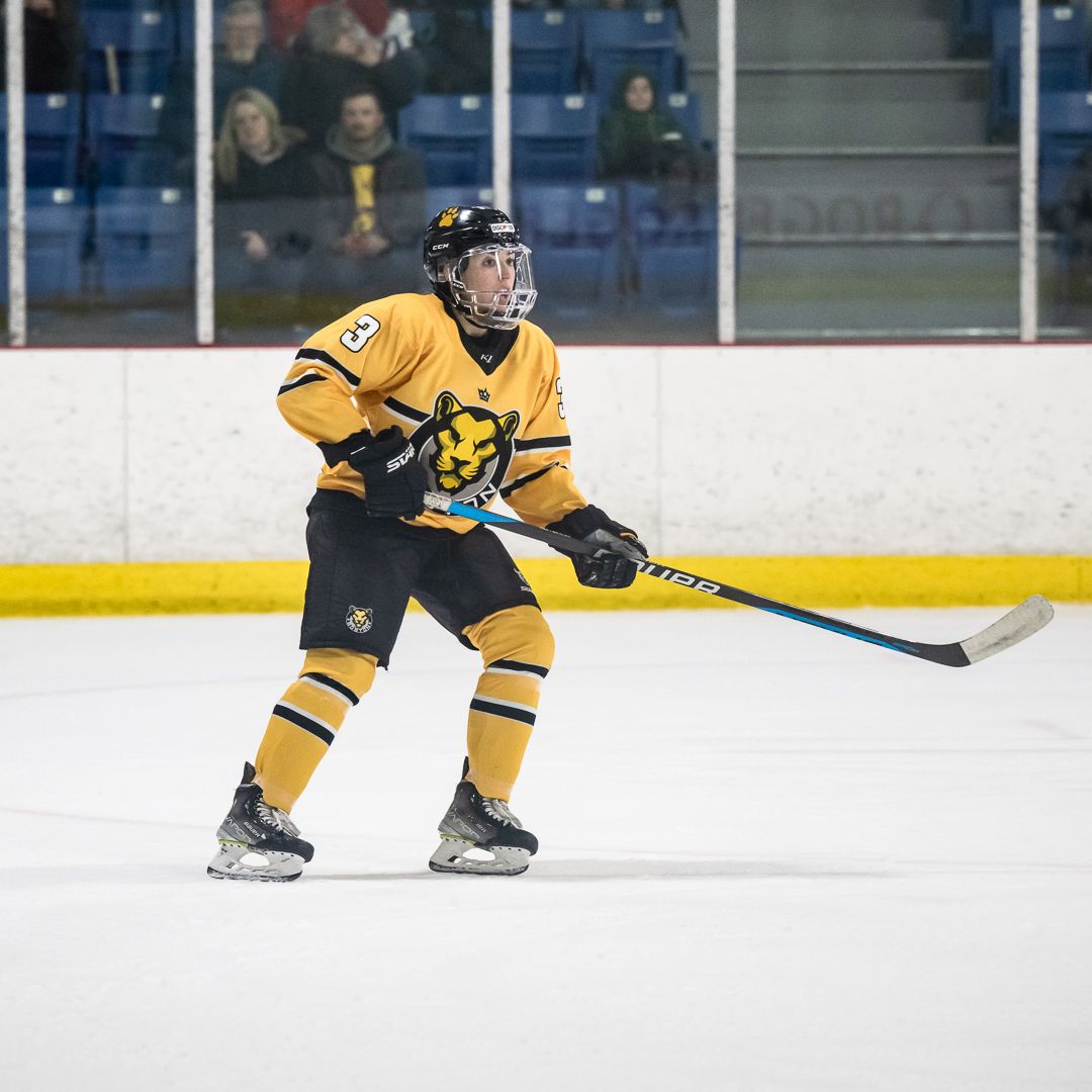 Olivia Zafuto in Boston's yellow uniform skating during a game.