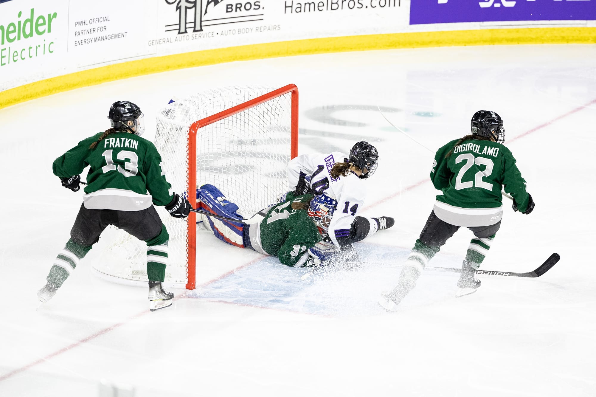 Clair DeGeorge, wearing her white away uniform, crashes into Aerin Frankel, wearing green home uniform.