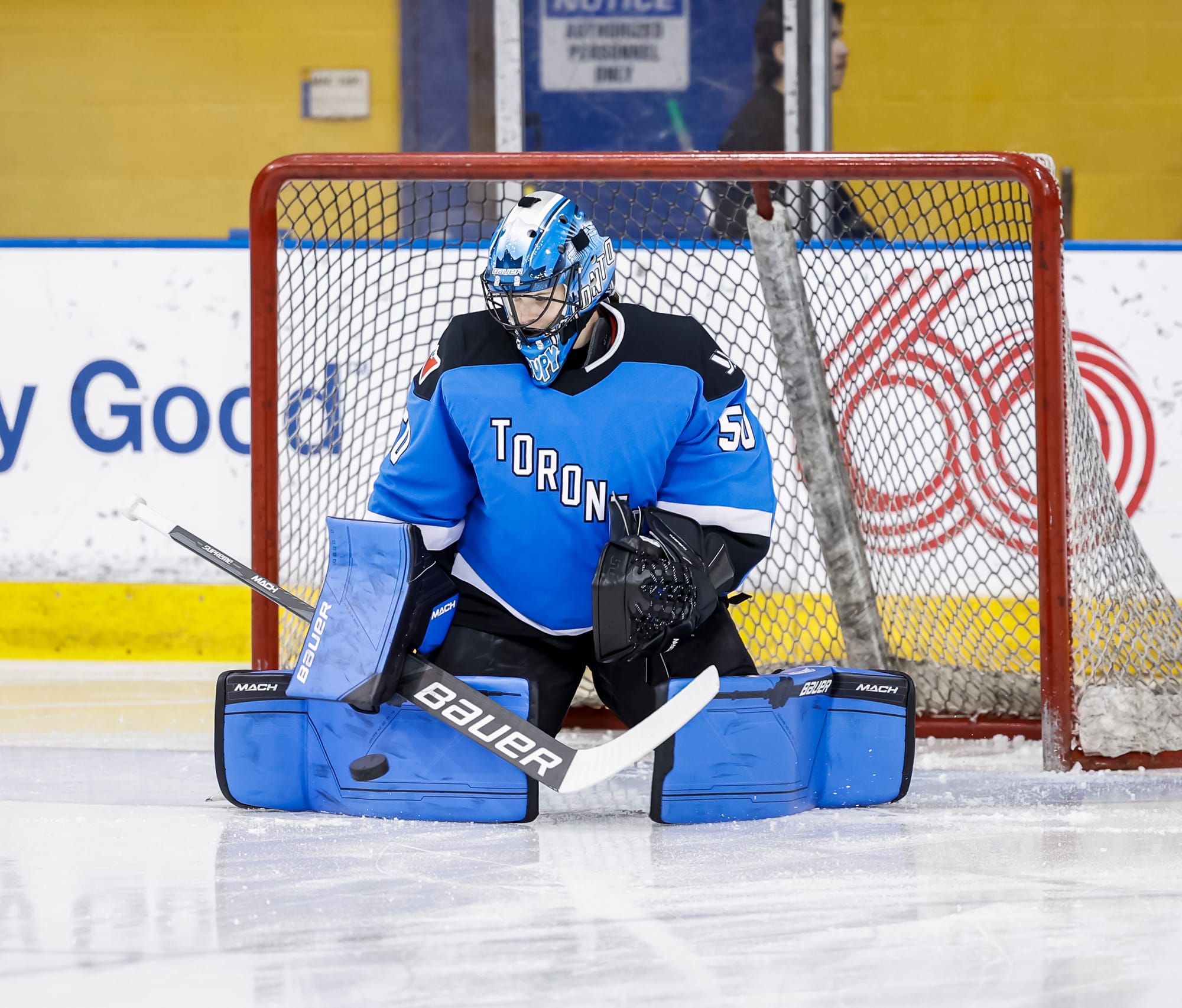 Kristen Campbell, wearing her blue Toronto gear and home jersey, makes a save during a game against Ottawa.