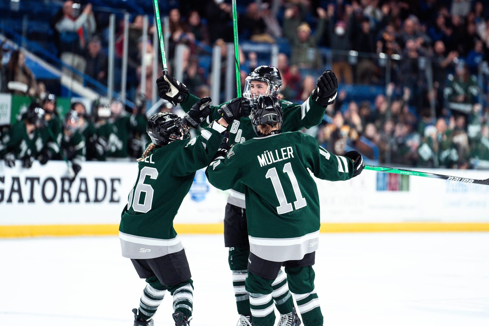 Loren Gabel and Alina Müller celebrate with Megan Keller after her goal.