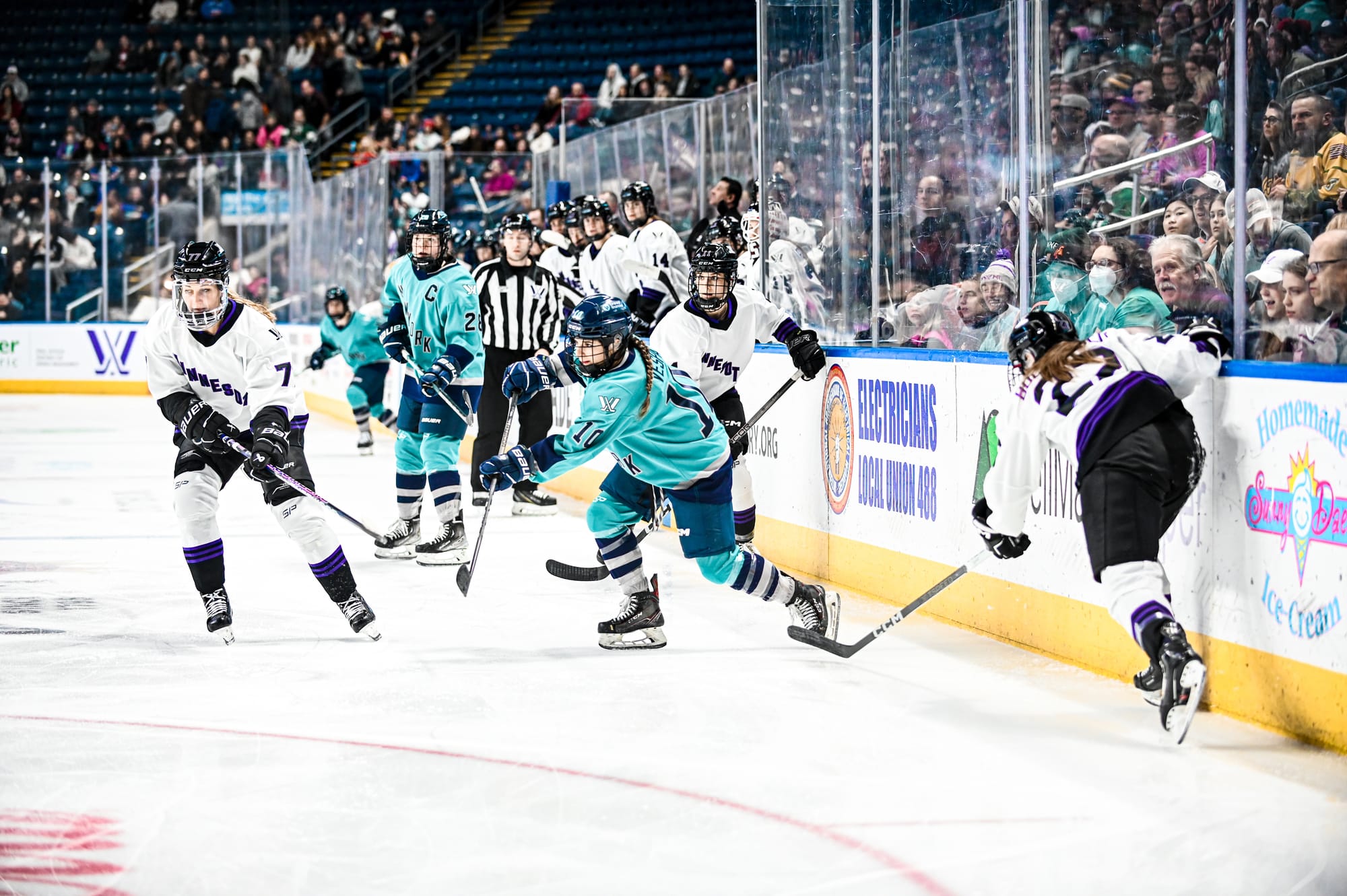 Kayla Vespa, wearing a teal home uniform, makes a pass during a game against Minnesota. 