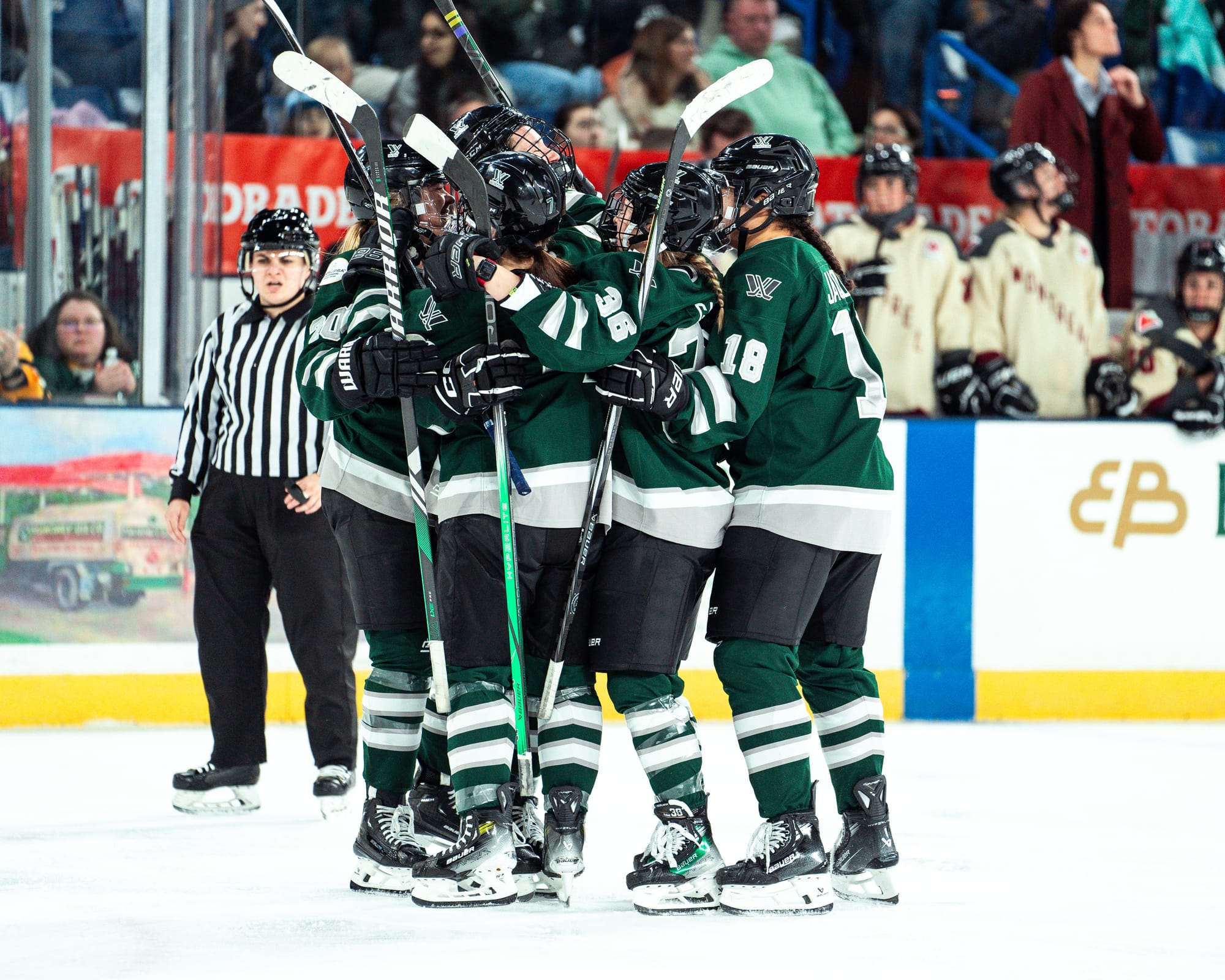 Wearing their green home uniforms, Boston players celebrate their goal against Montréal.