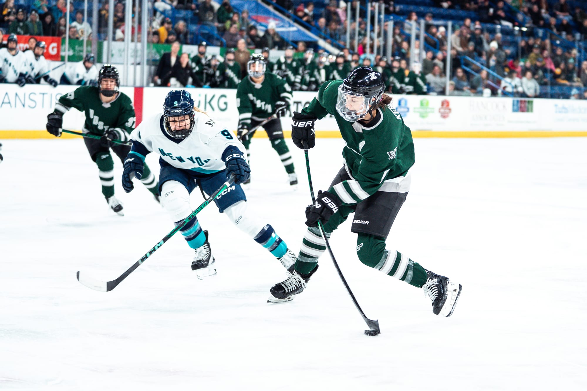 Megan Keller, wearing a green home uniform, takes a shot under pressure against New York