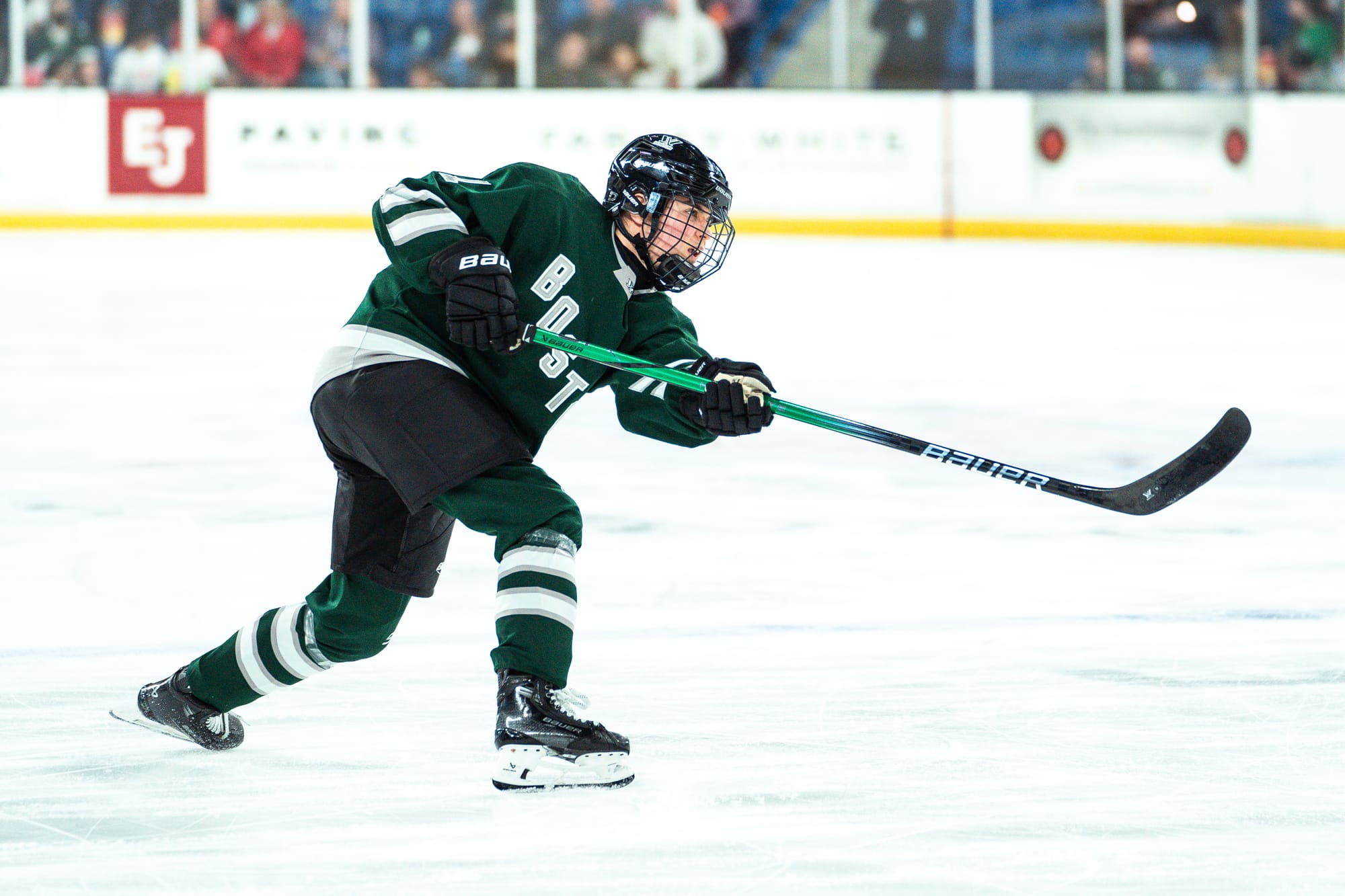 Alina Müller, wearing her green home uniform, takes a shot during Boston's game against New York. 