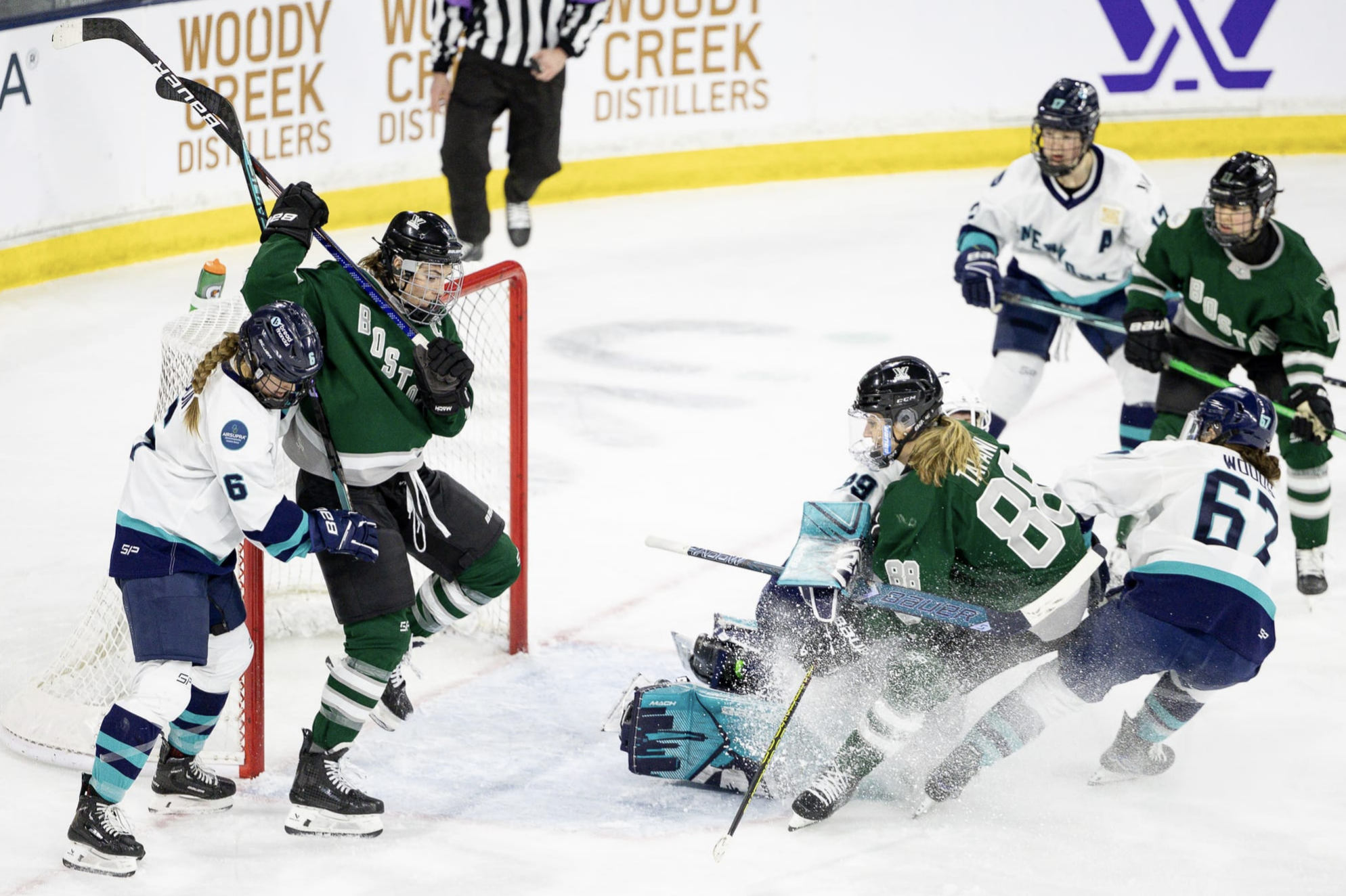 Chaos ensues in front of Abbey Levy. There are three New York players trying to tie up three Boston players. One of the pairs has run directly into Levy. The Boston players are in green, while the New York players are in white.