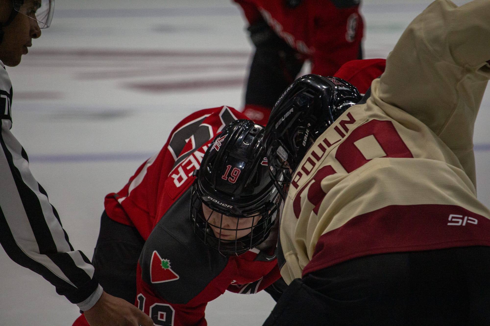 Brianne Jenner and Marie-Philip Poulin faceoff.