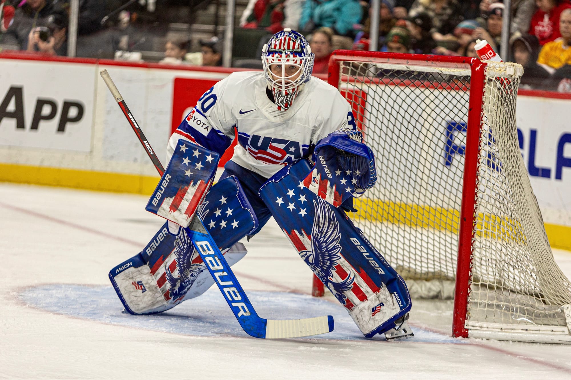 Levy sports a Team USA jersey along with her USA gear. The pads have an eagle spread across them with an American flag background. Her glove and blocker are also American flag themed, while she dons a red, white, and blue mask.