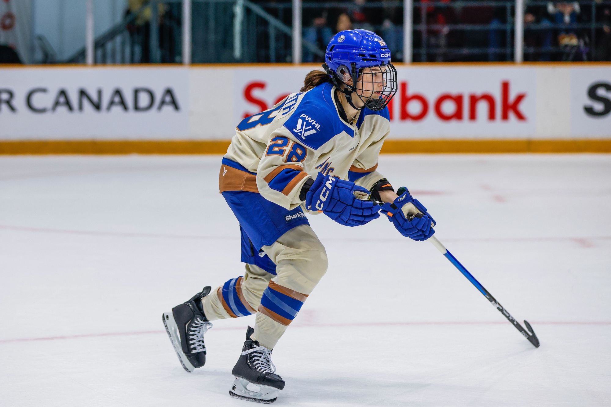 Jobst-Smith skates towards a play that is developing out of frame. She is wearing a cream away uniform.