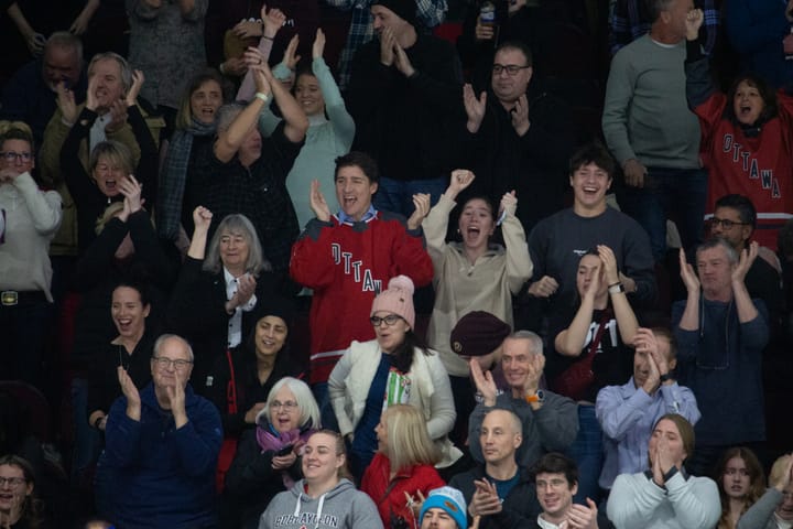 Justin, Ella Grace, and Xavier Trudeau cheer for a PWHL Ottawa goal