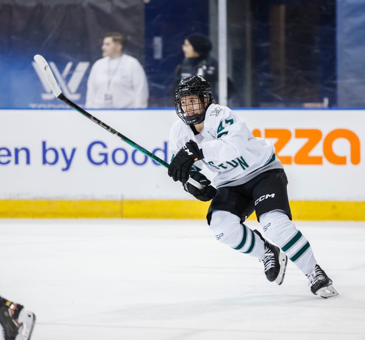 Jamie Lee Rattray, wearing her white away uniform, hunts the puck during a previous game. 