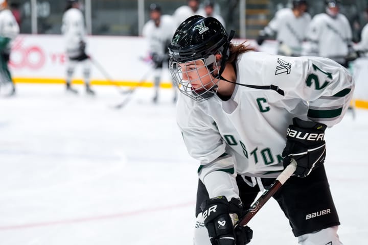 Hilary Knight, wearing a white away jersey, handles the puck during warm-ups.