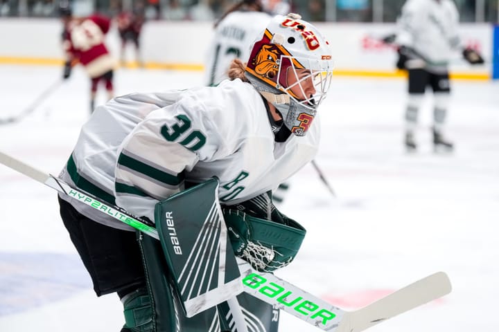 Emma Söderberg, wearing her UMD mask and green Boston bads, looks on during warm-ups against Montréal.
