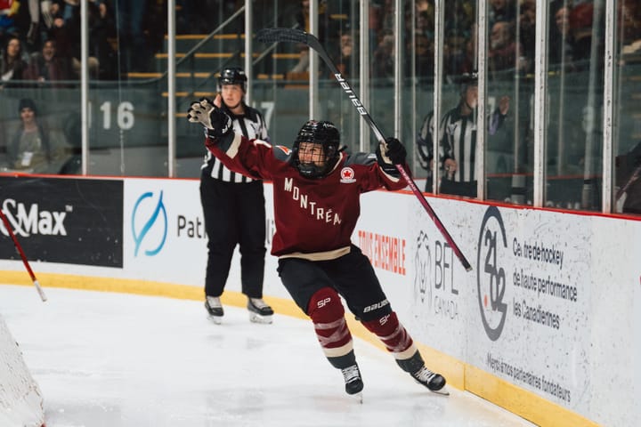 Ann-Sophie Bettez throws her hands in the air to celebrate her goal against Ottawa. She is wearing her maroon home uniform.