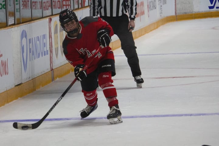 Amanda Boulier in a red Ottawa jersey takes a shot