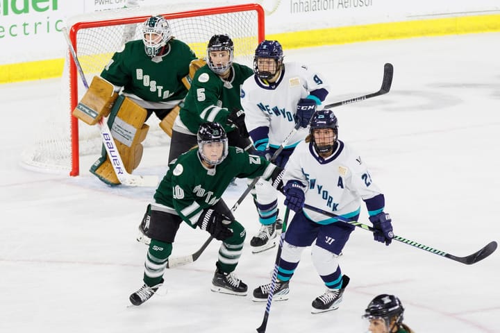 Hannah Brandt/Megan Keller (in green) battle with Alex Carpenter/Jessie Eldridge (in white) in front of Aerin Frankel. 