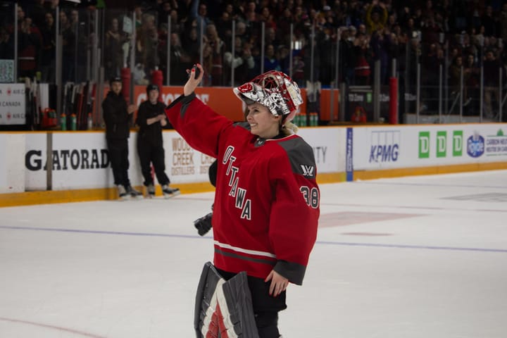 Goalie Emerance Maschmeyer waves to the crowd with a smile on her face.