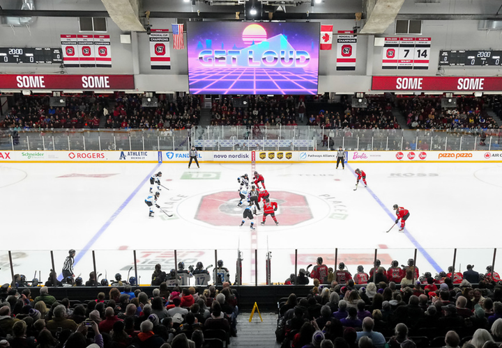 A distance shot of Ottawa and Toronto lined up for a faceoff. Ottawa is in red, Toronto is in white.