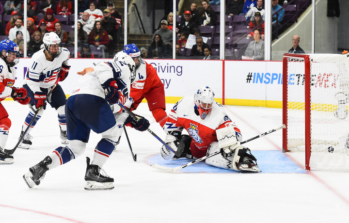 Janecke (in white) scores from above the left corner of the crease. The Czech goalie (in red) is in the butterfly.