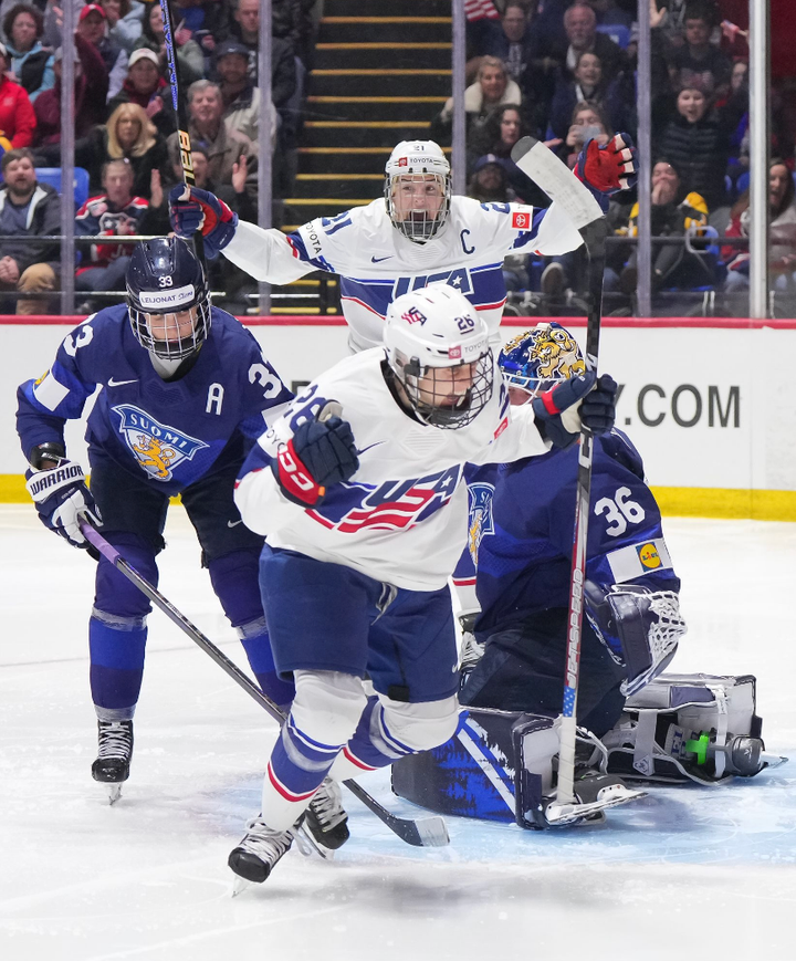 Coyne Schofield celebrates her goal, with Knight joining her in the background. Karvinen and Keisala are also visible.