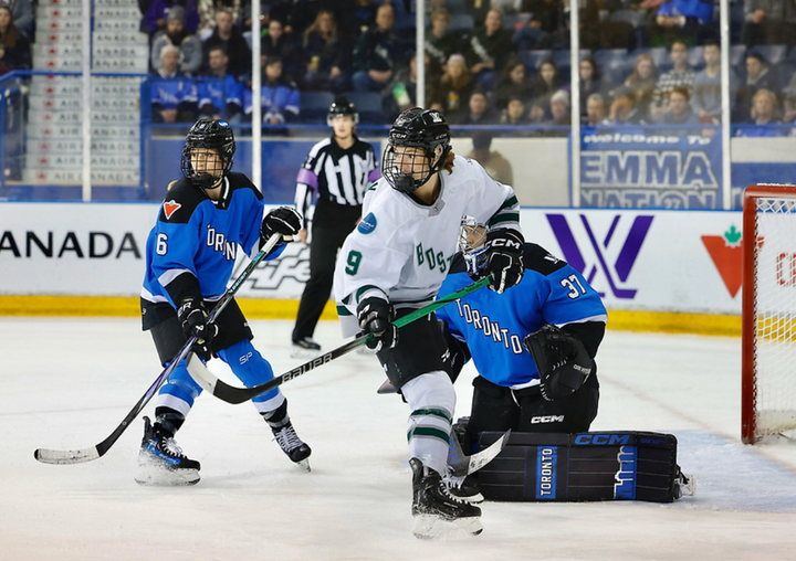 Shirley (right) and Flanagan (left) turn their heads to watch the play behind them while in front of Campbell's crease.