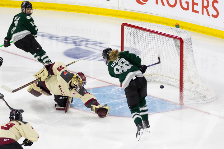 Tapani (right in green) pots the winner from outside the crease as Desbiens (left in cream) dives back to try to save it.